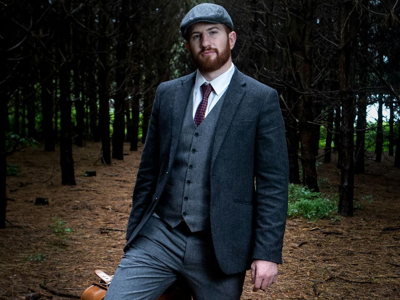 man in suit jacket carrying briefcase