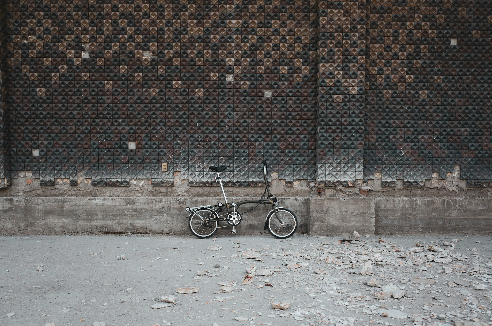 black bicycle on brown brick wall