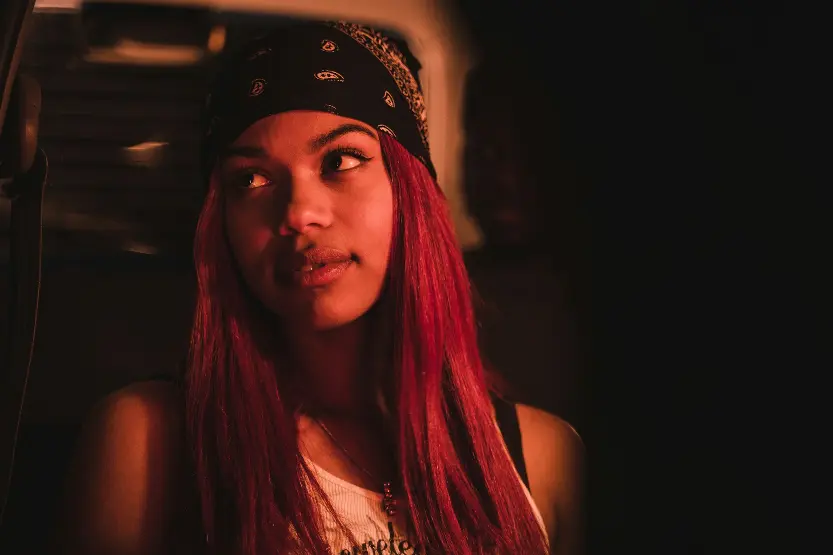 a woman with red hair wearing a bandana